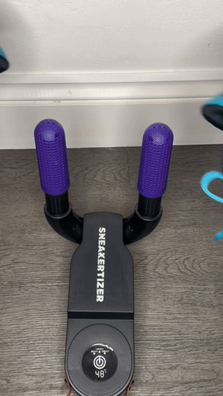 Bright green Nike football boots on Sneakertizer™ a tissue wipe proves the inside is fully dry—boots come out fresh, clean, and ready.